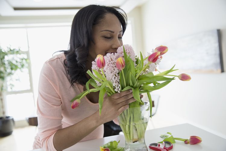 Woman smelling bouquet of flowers